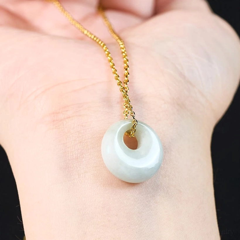 Jade pendant necklace worn on human palm showing real-life size and wearing effect