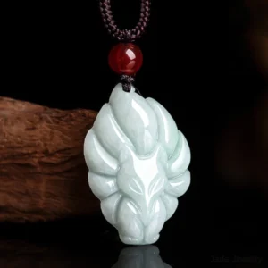 Complete nine-tailed fox jade pendant necklace set with hand-woven natural fiber cord, red agate accent bead, and premium celadon jade carving on wooden background