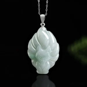 Light green jade nine-tailed fox pendant necklace close-up, intricate fox carving with silver bail on black background
