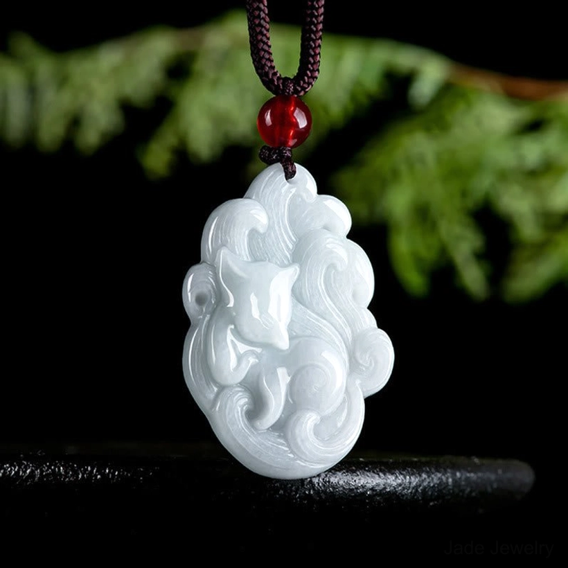 Hand-carved nine-tailed fox jade pendant three quarter angle view showing detailed carving