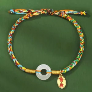 Adjustable jade peace buckle bracelet with colorful braided cord and engraved metal tag detail