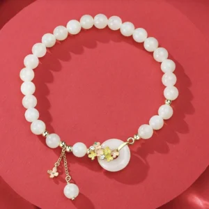 Natural hetian jade beads and osmanthus flower peace buckle pendant - circle composition on red background