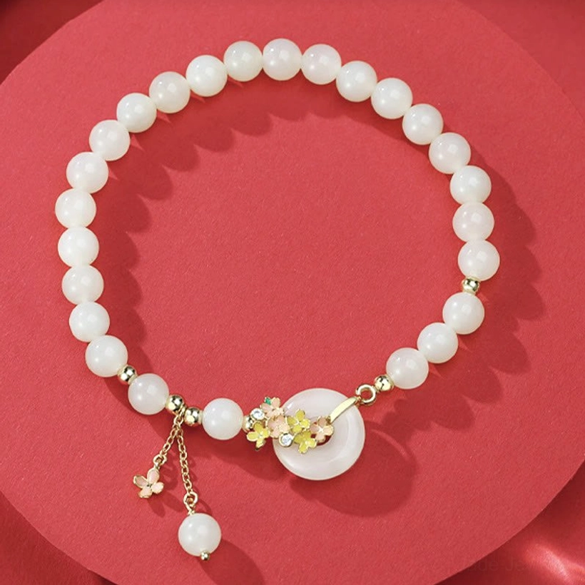Natural hetian jade beads and osmanthus flower peace buckle pendant - circle composition on red background