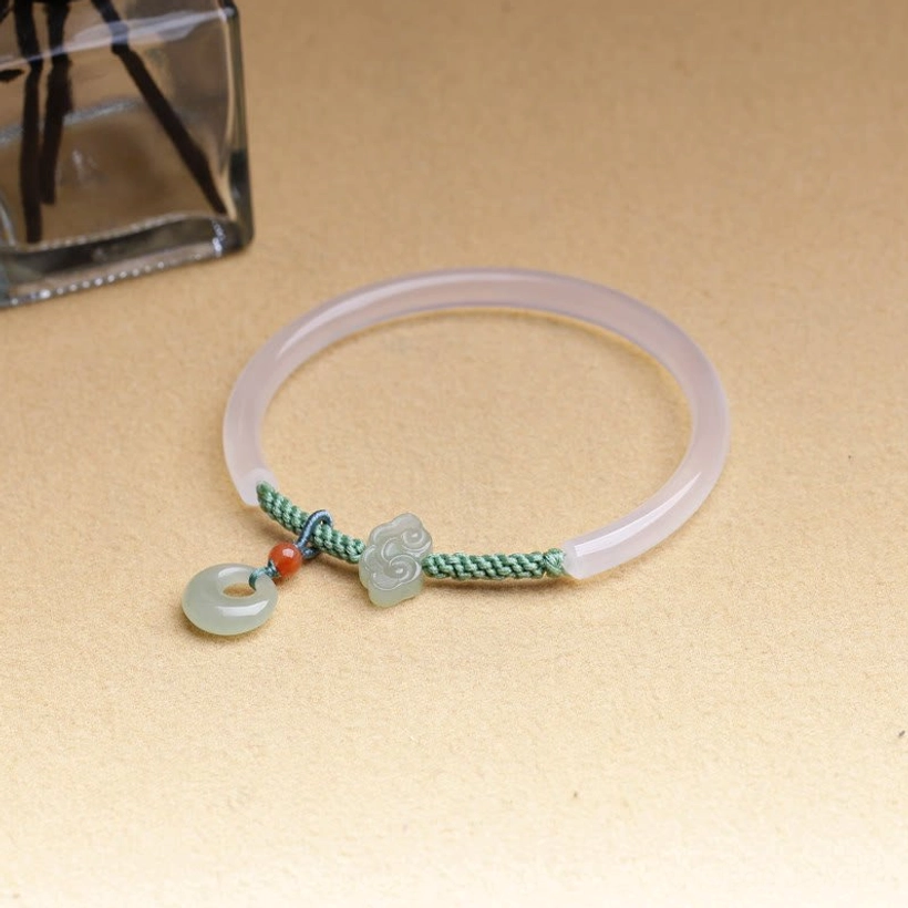 Hetian jade and white agate peace buckle bracelet detail shot emphasizing authentic handmade jade charm and cord quality