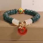 Jade peace buckle bracelet with red white agate beads and gold spacer - double wrap styling on jewelry tray