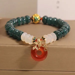Jade peace buckle bracelet with red white agate beads and gold spacer - double wrap styling on jewelry tray