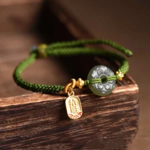Braided green rope jade peace buckle bracelet close-up side angle showing details