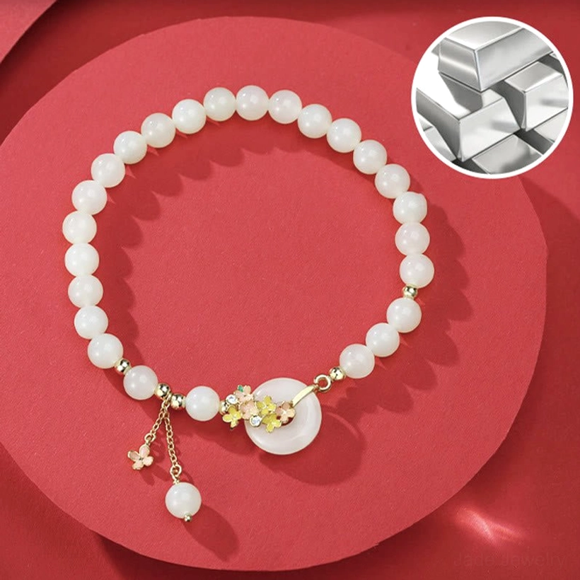 Hetian jade peace buckle bracelet with sterling silver raw material detail on red circular background