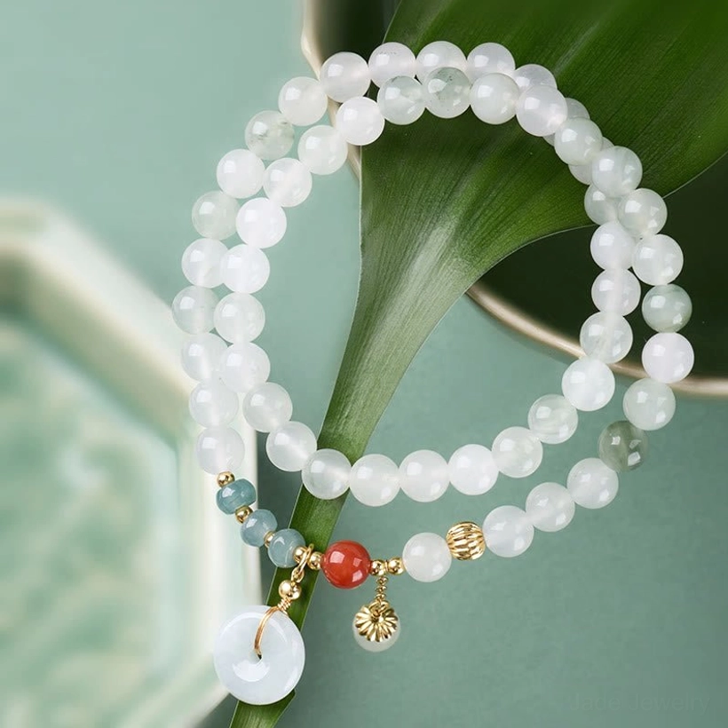 Close-up jade peace buckle bracelet showing white jade beads red agate and blue stone accents with peace buckle charm