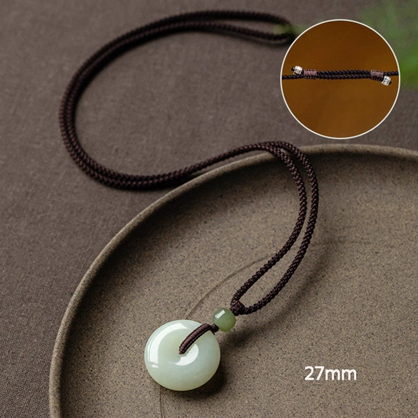 Natural jade peace buckle good fortune protection pendant ancient Chinese tradition spiritual meaning