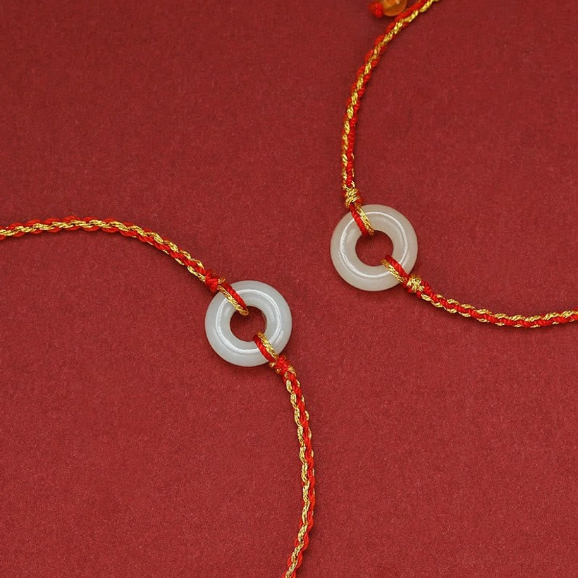 Two matching handmade jade peace buckle braided bracelets anklets displayed separately, showing consistent craftsmanship