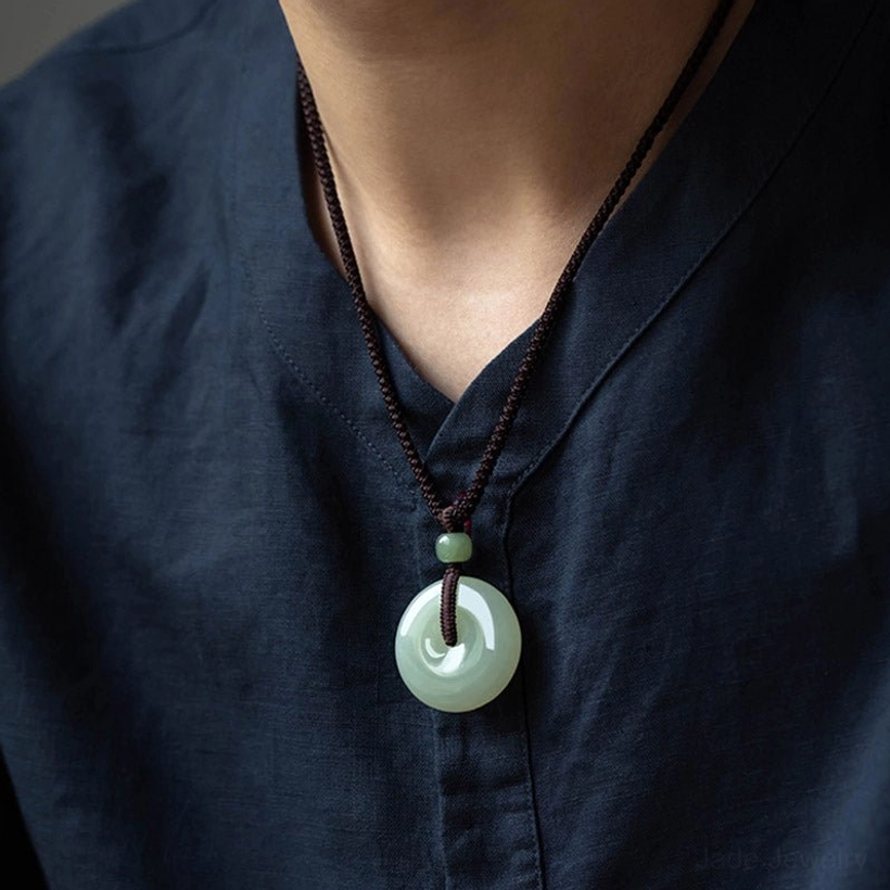 Jade peace buckle necklace worn on male neck with dark blue shirt demonstrating minimalist casual daily style