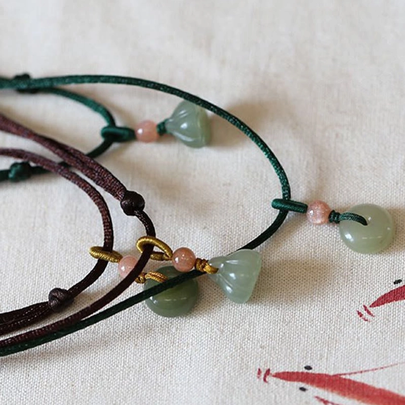 Jade peace buckle necklace adjustable cord with knot detail, close-up