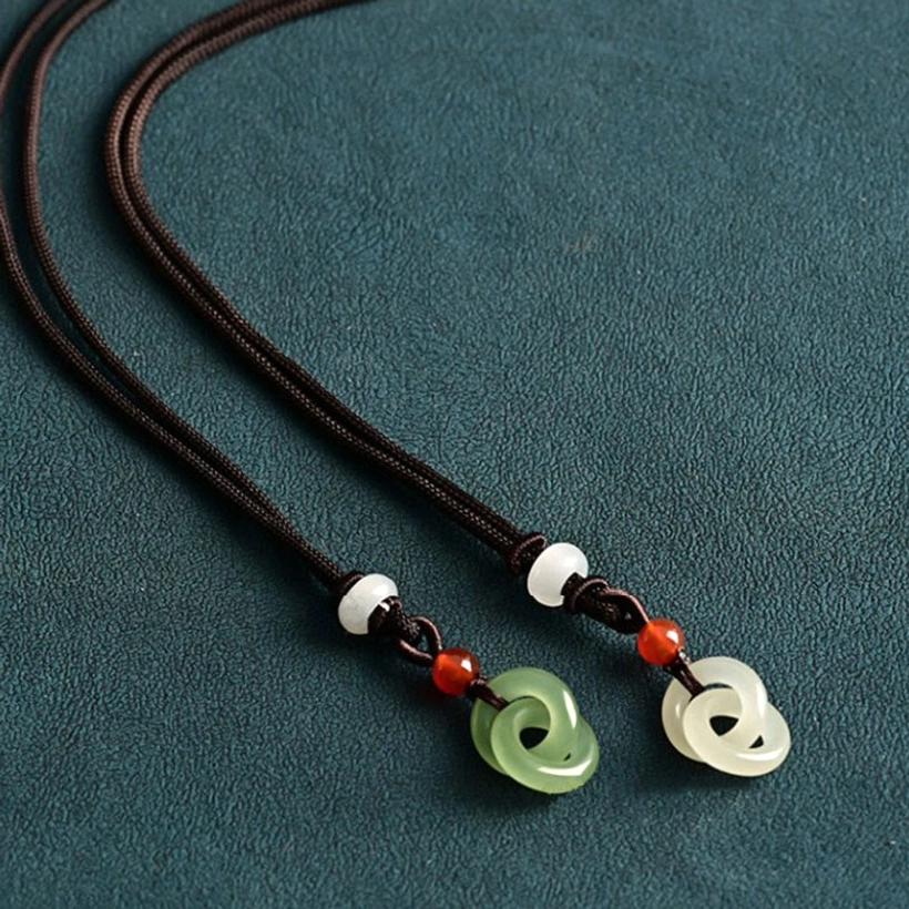 Detailed craftsmanship view of hetian jade peace buckle necklace pendant and braided cord assembly