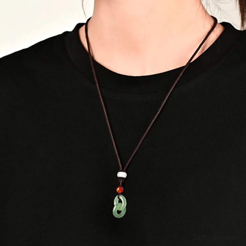 Hetian jade peace buckle necklace worn on model with brown braided chain featuring cyan jade double ring pendant