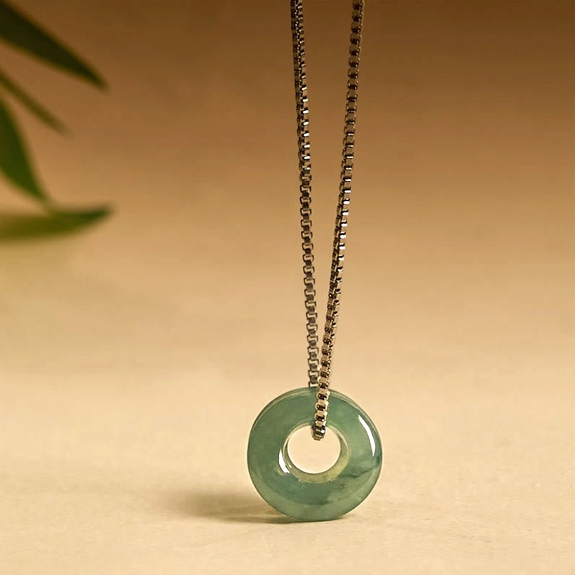 Jade peace buckle necklace pendant detail showing smooth polished surface and circular design symbolism