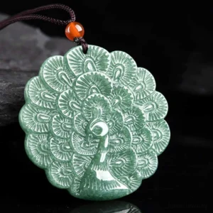 Jade peacock pendant necklace with brown cord and red agate bead, side angle view displaying 3D hand-carved design