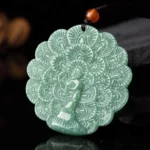 Carved jade peacock pendant with intricate feather details in vibrant green jade, front overhead view showcasing the fortune symbol
