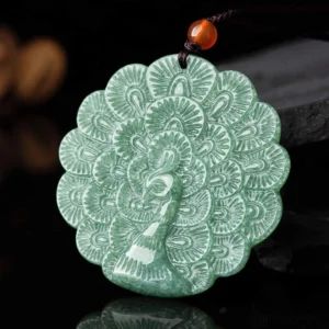 Carved jade peacock pendant with intricate feather details in vibrant green jade, front overhead view showcasing the fortune symbol