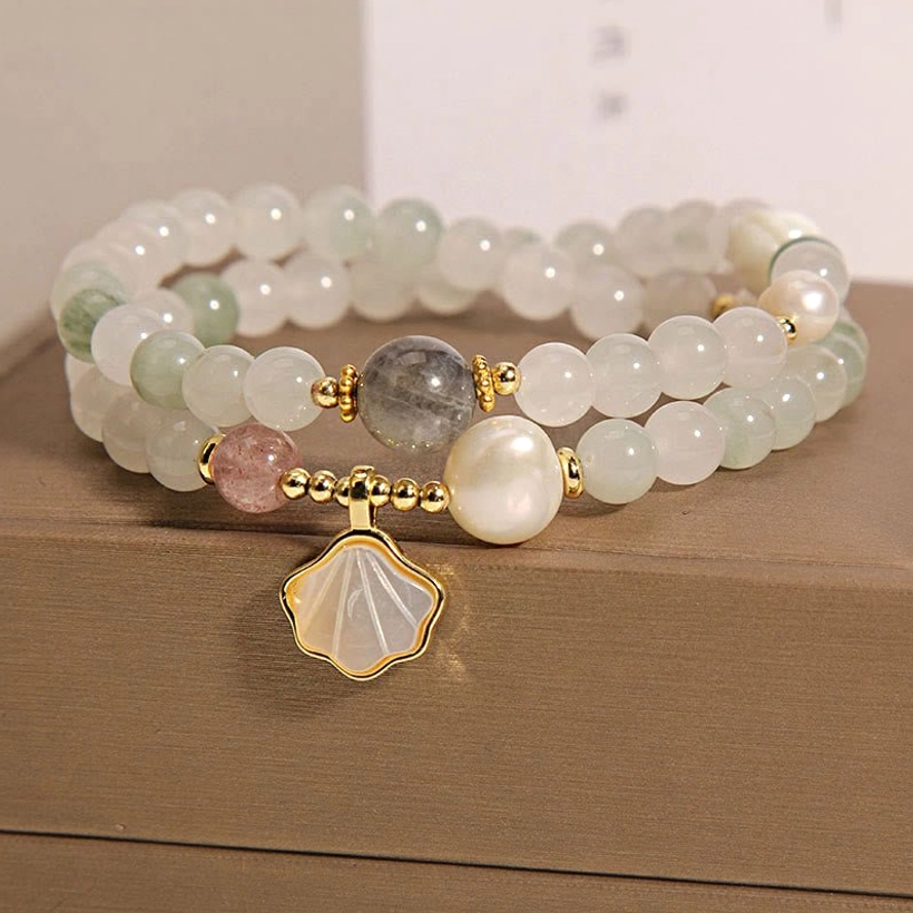 Pale green jade and freshwater pearl beaded bracelet with shell charm and gold clasp side view