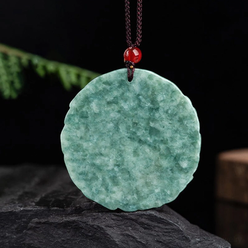 Smooth reverse side of natural green jade pendant without carving