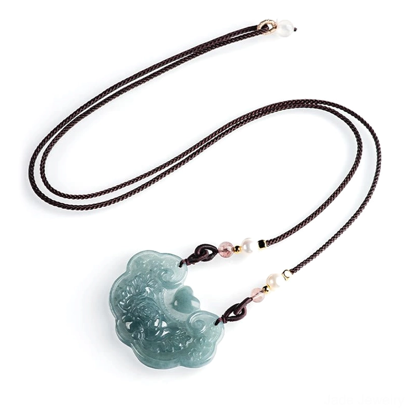 Jade pendant necklace flat lay with dark brown braided cord, complete set showing attached jade lock pendant and beaded accents