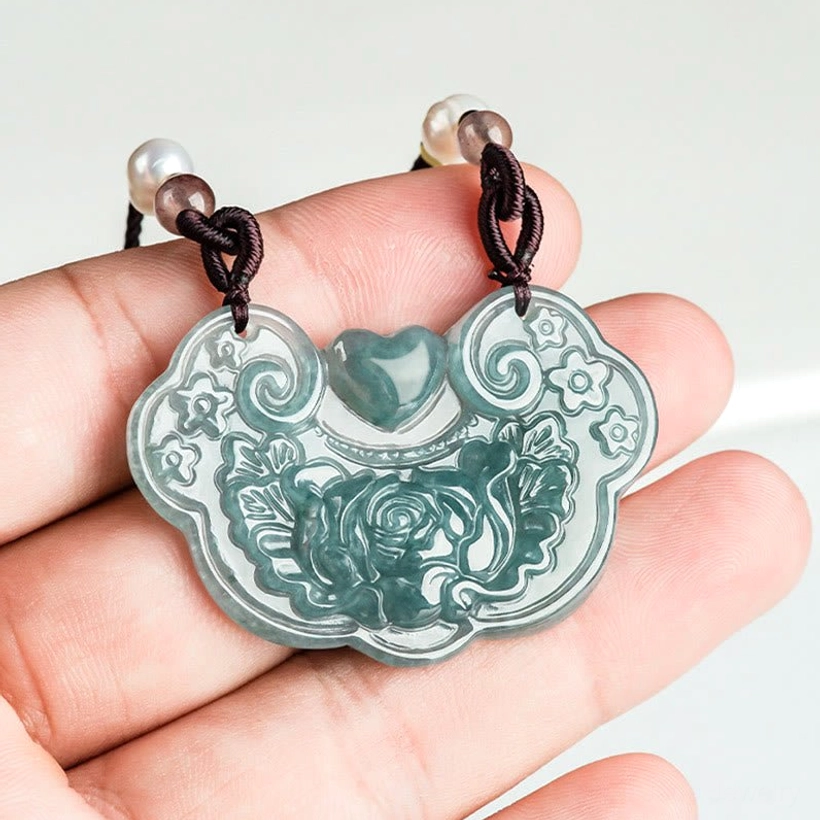 Jade peony lock pendant held in hand showing actual size 32.5x47mm, natural jade texture and carved floral details, wearable charm