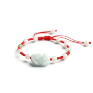 Natural jade Pi Xiu wealth bracelet with red protective cord, adjustable sliding knot design, top-down side view showing carved jade bead and woven red string