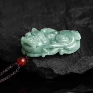 Hand-carved green jade Pixiu pendant detailed side view showing intricate mythical beast carving