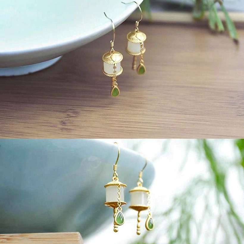 Jade prayer wheel drop earrings for prosperity and abundance, featuring sterling silver hooks and milky white jade with green teardrop charm decoration