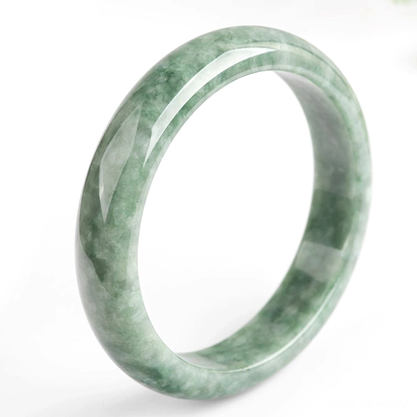 Green jade fortune bangle bracelet on white background, right three-quarter view displaying smooth polished finish and jade texture