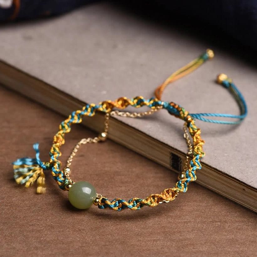 Adjustable jade prosperity bracelet with braided rope and drawstring closure, handmade detail