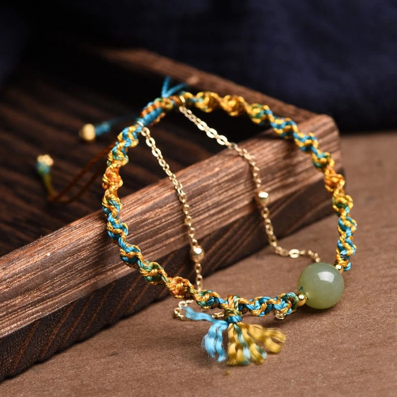 Double layer jade abundance bracelet with metal chain and tassel pendant, artisanal craftsmanship detail