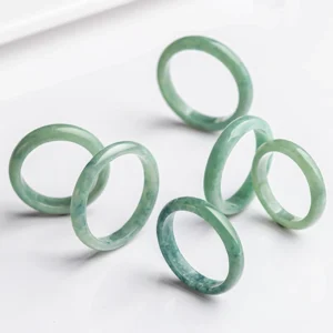 Multiple sizes natural jade prosperity rings flat lay comparison green jade bands