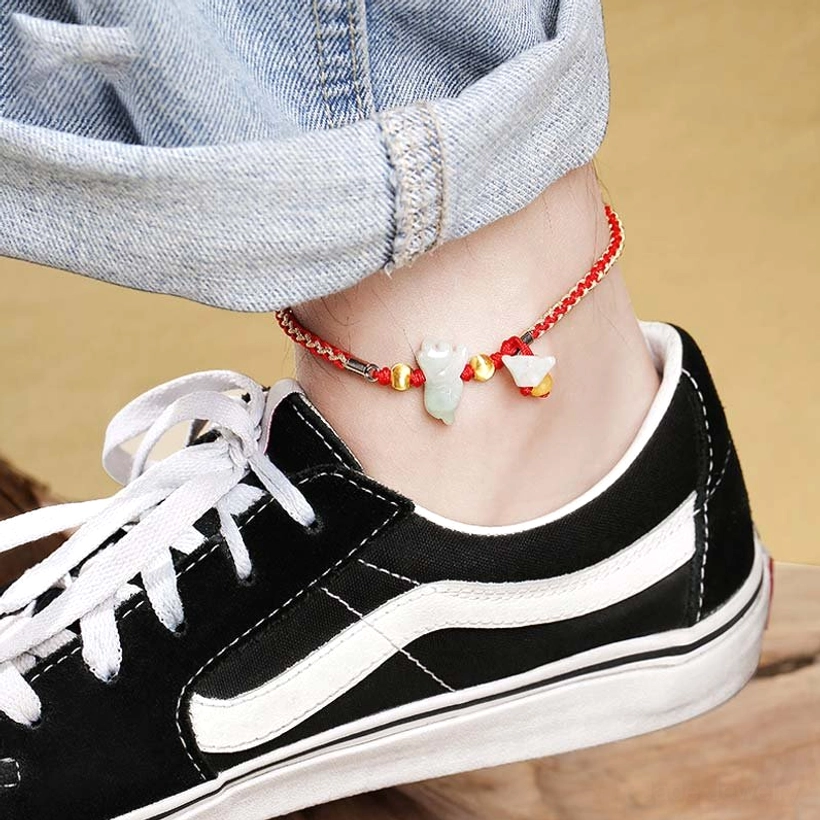Jade prosperity anklet with red cord and silver clasp worn on ankle, paired with jeans and black sneakers for daily wear