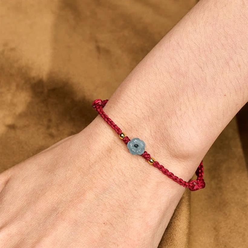 Jade red string bracelet worn on wrist showing adjustable side knot and protection bracelet in real-life wear