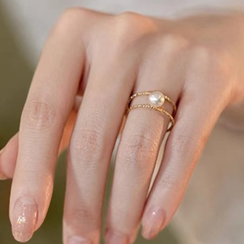 Adjustable jade ring product flat lay showing texture of natural jade stone and gold-tone metal construction