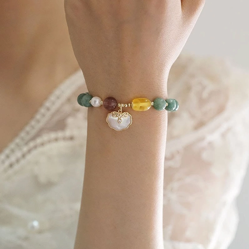 Jade Ruyi lock bracelet worn on left wrist with lace wedding dress background - wrist close-up