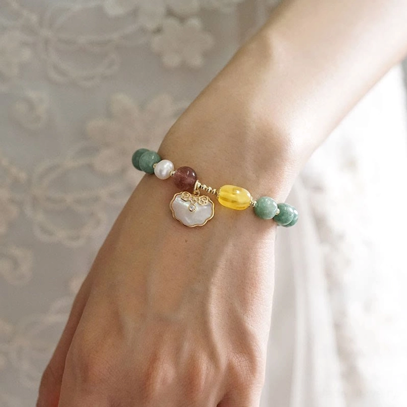 Jade Ruyi lock bracelet fitted on right wrist showing charm detail - side close-up with embossed floral lace