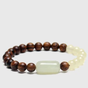 Jade and sandalwood 108 mala beads bracelet flat lay top view showing dark wood beads and pale jade decorative beads