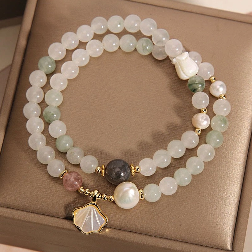 Single and double-layer jade beaded bracelets with pink gemstone and shell pendant on brown box