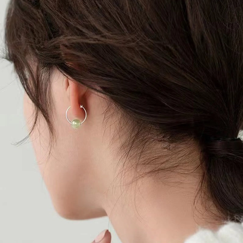 Sterling silver jade earrings craftsmanship detail - handmade artisan work showing quality polishing and jade bead attachment on silver posts