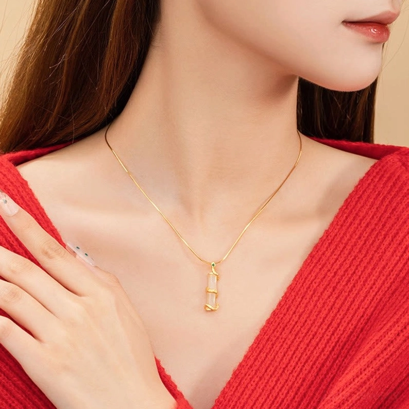 Hetian jade snake bamboo pendant close-up - hand touching pendant on neck showing natural jade luster and silver wrapping