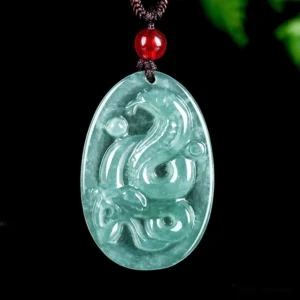Natural jade snake zodiac pendant necklace on dark background with green foliage, year of the snake 2025