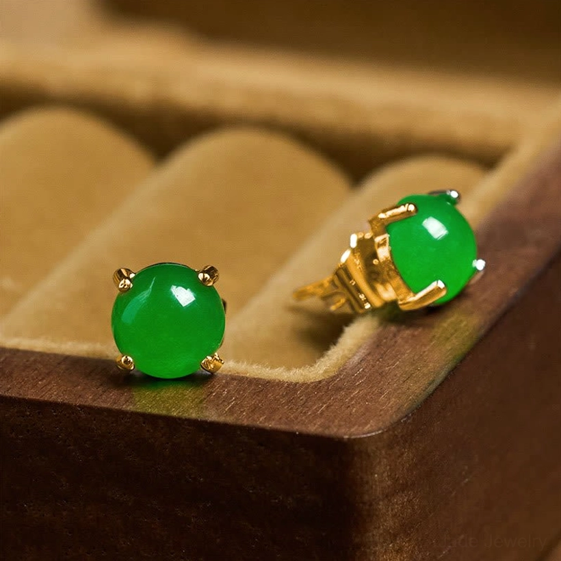Side profile view of jade stud earring with gold-plated silver post in velvet-lined jewelry box