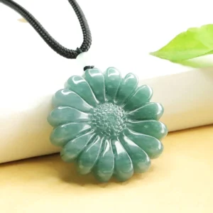 Natural jade sunflower pendant with carved floral details, oblique angle showing depth and polished finish