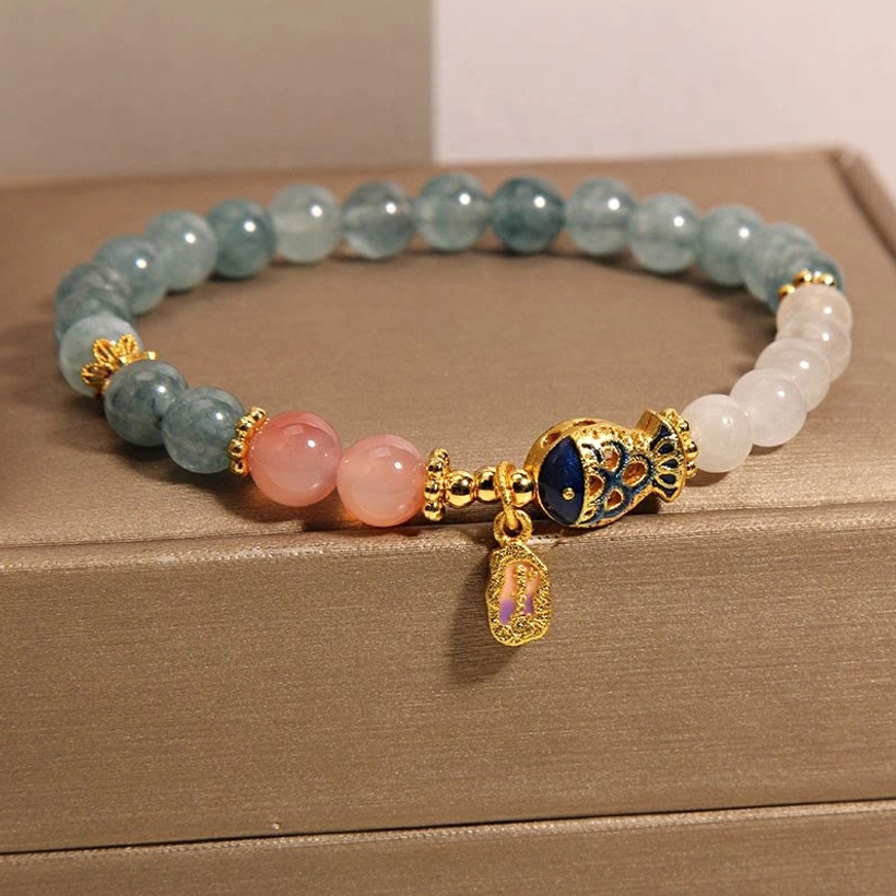 Gold enamel koi fish charm on jade prosperity bracelet front angle view in jewelry presentation box