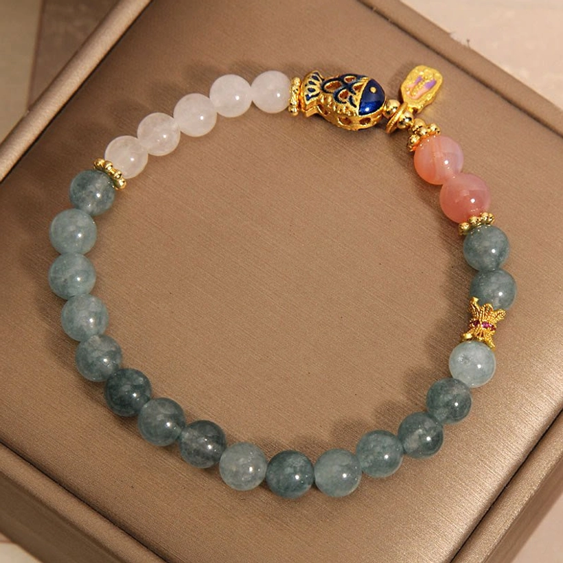Premium white jade koi fish luck bracelet with gold accents displayed in luxury jewelry box