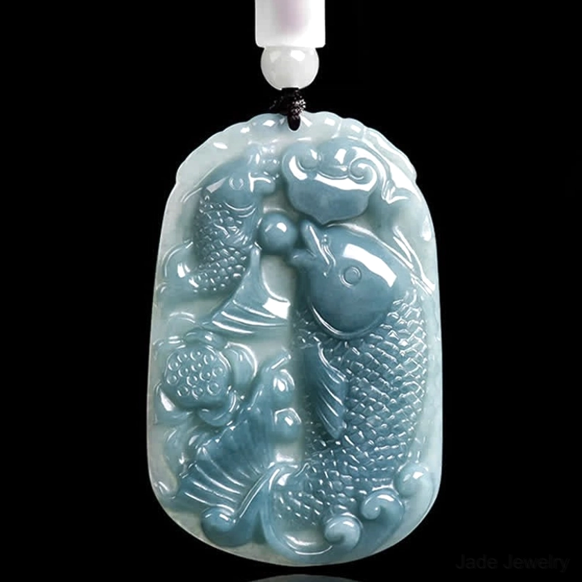 Handcrafted double koi fish jade pendant necklace front flat view, detailed hand-carved koi patterns on natural jade stone with beaded cord against dark studio background