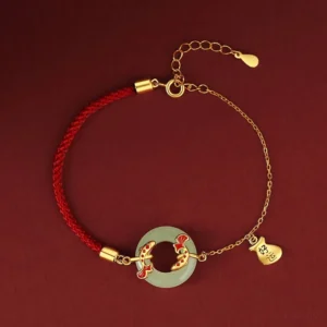 Sterling silver and jade koi fish bracelet front flat display showing adjustable gold chain and red cord